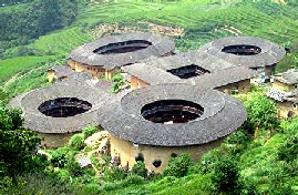 Examples of Hakka tu lou buildings in Fujian with terraced rice fields in back.