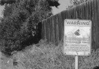 A photograph of a Neighborhood Watch sign in grayscale