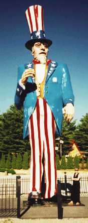 The tallest (38 ft (11.6 m)) Uncle Sam in  towers over 5 ft 4 in (163 cm) Alison.