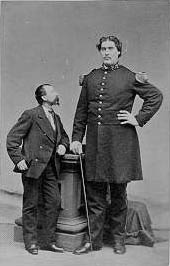 Bates, right, in uniform, next to a man of average height