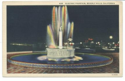 Fountain with colored lights at intersection of Wilshire Blvd. and Santa Monica Blvd. in Beverly Hills, California