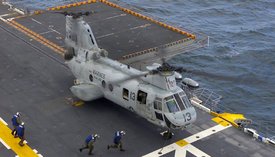 April 1, 2004: Sailors from  rush out to unchain a CH-46 Sea Knight.