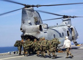 October 20, 2002: members of the  board a CH-46 Sea Knight helicopter on , during beach-landing training.