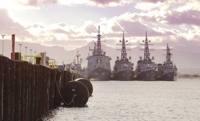 Japanese defense forces are docked at Pearl Harbor in RIMPAC 2002 ironically near ruins of the USS Arizona, destroyed by the Japanese navy in 1941.  Japan is a regular participant.  Left to right: JDS Kirishima, JDS Murasame, JDS Ikazuchi and JDS Hamagiri.