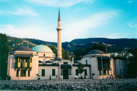 Pedestrians walk by the Tzar's mosque, the oldest mosque in Sarajevo.