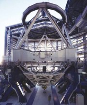 One of the four telescopes that make up the VLT, named Kueyen. The 8.2 m mirror can be seen below the large horizontal grey beam (as an oval patch of lightness). Image courtesy of the .