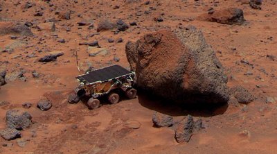 The Sojourner Rover is taking its Alpha Proton X-ray Spectrometer measurement of Yogi the Rock (NASA)