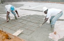 Installing rebar in a floor during a concrete pour