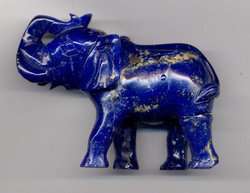 A carving in high quality lapis lazuli, showing gold-colored inclusions of . These inclusions are common in lapis and are an important help in identifying the stone. The carving is 8 cm (3 inches) long.