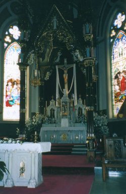 The Original High Altar at the , .  As the parish offers  Masses, this altar is still used for such services.