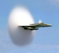 When an aircraft breaks the sound barrier, an unusual cloud sometimes forms in its wake. A drop in pressure, due to shock wave formation, causes a sharp drop in temperature, leading water vapor to condense into droplets and form the cloud.