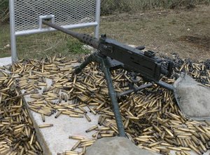 An M2 machine gun surrounded by spent shell casings