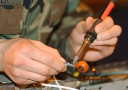 (De)soldering a contact from a wire.