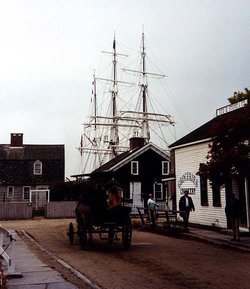 Street in Mystic Seaport, masts of Charles W. Morgan in background