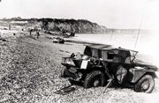 Dieppe's pebble beach and cliff immediately following the raid on August 19th, 1942. A scout car has been abandoned.