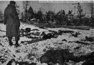 United States soldiers discover the aftermath of the Malmdy Massacre.