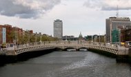 Dublin's Ha'penny Bridge. Beyond it, the dome of the   and , the city's tallest building.