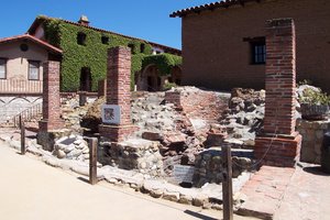 A view of the  at Mission San Juan Capistrano, the oldest existing facilities (circa ) of their kind in the State of California.  The sign at the lower right-hand corner proclaims the site as being "...part of Orange County's first industrial complex."