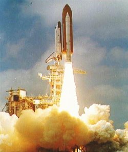 STS-3 speeds away from Launch Complex 39 at .  Note the bright orange flame from the  combustion of ammonium perchlorate and aluminum compared to the blue and clear flame of hydrogen and oxygen from the .