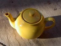 A yellow ceramic teapot