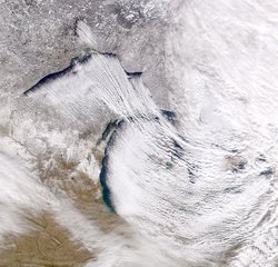 Streaming lake-effect clouds off Lakes ,  and . Wind direction is southeastward, becoming eastward as the clouds extend to the east.