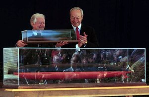 President Carter holding a model of the ship that will carry his name.