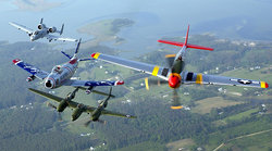 An , ,  and  fly in formation during an air show at Langley Air Force Base, Virginia. The formation displays four generations of Air Force aircraft