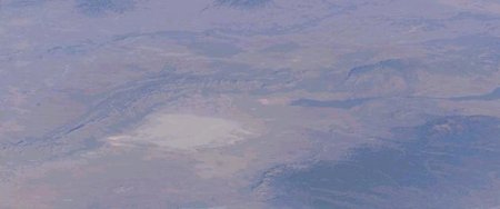 The top half of the image, which is oriented with the top to the northwest, is the Jornada del Muerto. The bottom half of the image is the Tularosa Bbasin, and the forested  to the east, with the tallest peak, Sierra Blanca, a ski resort, at 12,000 feet altitude. The  are in the Tularosa Basin. The  is the dark streak of lava, north of White Sands. Trinity Site is northwest of the Malpais. Earth Sciences and Image Analysis, NASA-Johnson Space Center. 29 Dec. 2003