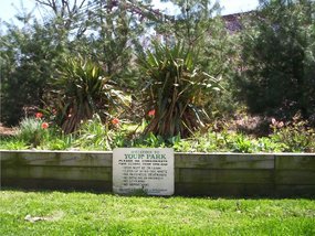 Picture of the flower garden in the center of Gateway Park. Note that the sign still says "Your Park" which is incorrect.