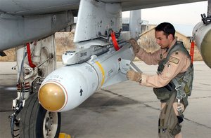 A pilot inspects an AGM-65 Maverick missile on his .