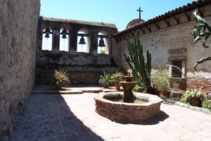 A view of Mission San Juan Capistrano's "Sacred Garden" developed in .  The four-bell campanario was erected a year after the bell tower at "The Great Stone Church" was toppled in an earthquake.
