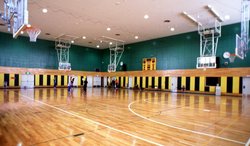 Modern indoor gymnasium with pull-down basketball hoops