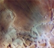 In this  image, the canyons are filled with mist from frost sublimated by the early-morning sun. (South is toward the top.) Courtesy NASA/JPL-Caltech.
