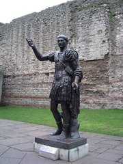 Statue of  in front of a section of the Roman wall, Tower Hill