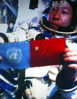 Yang Liwei pictured in orbit during the  mission with  and  flags.