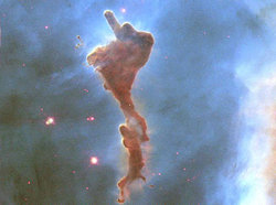 Within a few million years the light from bright stars will have boiled away this molecular cloud of gas and dust. The cloud has broken off from the . Newly formed stars are visible nearby, their images reddened by blue light being preferentially scattered by the pervasive dust. This image spans about two light years and was taken by the orbiting Hubble Space Telescope in 1999.