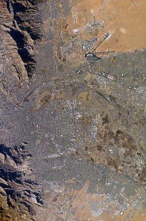 El Paso (top) and Ciudad Jurez (bottom) as seen from earth orbit; the Rio Grande River is the thin line separating the two cities through the middle of the photograph. A portion of the Franklin Mountains can be seen in the upper-left. Image courtesy of NASA.