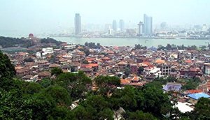 Gulangyu Island (foreground) has retained its traditional architecture compared to  (background)