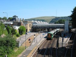 The modern non-terminus Lewes Station in ,  serves trains passing through the station.  Passengers reach the island platform (on right) by a pedestrian footbridge.