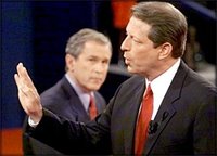 Al Gore makes a point during a  during the 2000 election as George W. Bush looks on.