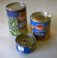 Three tin cans of varying sizes; the one on front is opened with a pull tab.