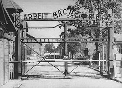 Entrance to Auschwitz in 1941. The slogan  over the gate translates as "Work (shall) make (you) free" (or "work liberates")