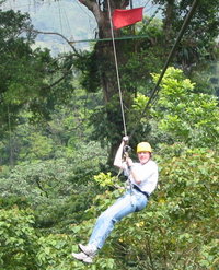 On this  zip-line between platforms in trees in , the rider controls speed with a leather glove .