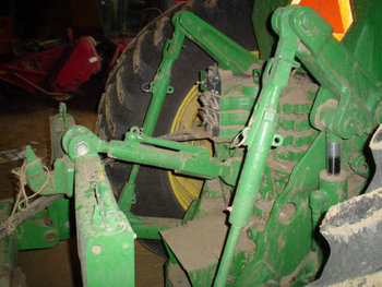 A three-point hitch with an implement attached.