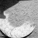 Ring shaped object, partially buried in Martian soil