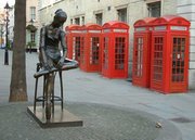 Red telephone boxes behind Enzo Plazzotta's bronze, "Young Dancer", on Broad Street, Covent Garden, London