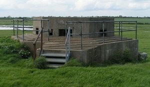 A pillbox on the East coast of England. Part of the defences were built during World War II (the railings are a modern addition)
