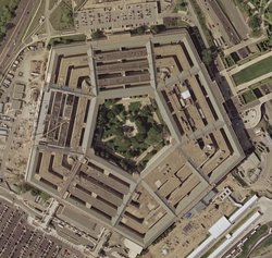 Satellite image of the Pentagon from the , taken April 26, 2002.  The reconstruction of the section damaged on  is visible on the building's west (left) side; the diagonal line is a construction crane