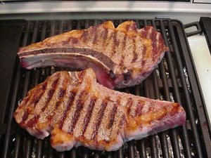  A pair of ribeye steaks being grilled
