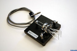A commercially manufactured iambic paddle used in conjunction with an electronic keyer to generate high-speed Morse code.